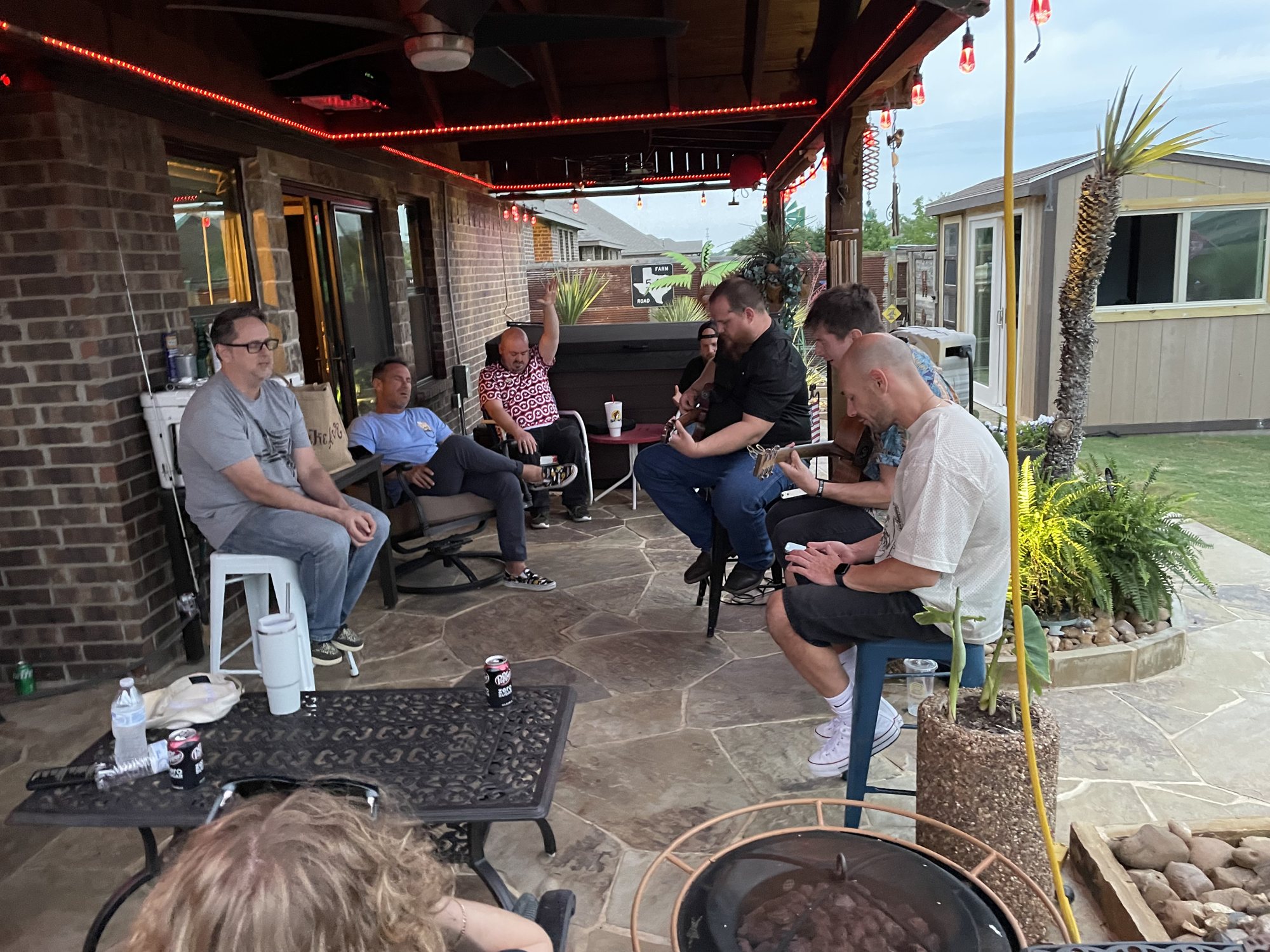 Men gathered around a patio table in fellowship